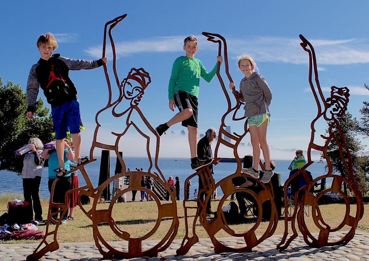 Kids clambered on the Luna Girls sculpture by Lezlie Jane as they waited for the eclipse to start. Photo by Kimberly Robinson