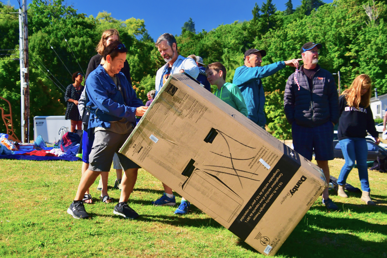 A family brought a card board  refrigerator box they had converted to a viewer. Photo by Patrick Robinson