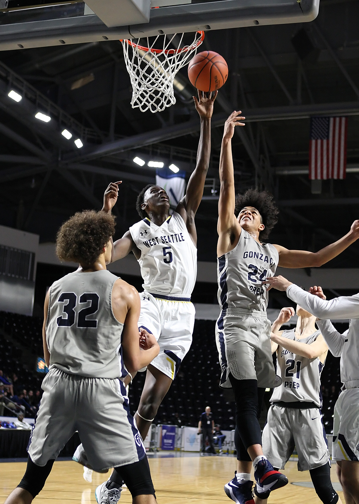 : Abdullahi Mohamed of West Seattle and Gonzaga Prep’s go after a loose ball under the basket.