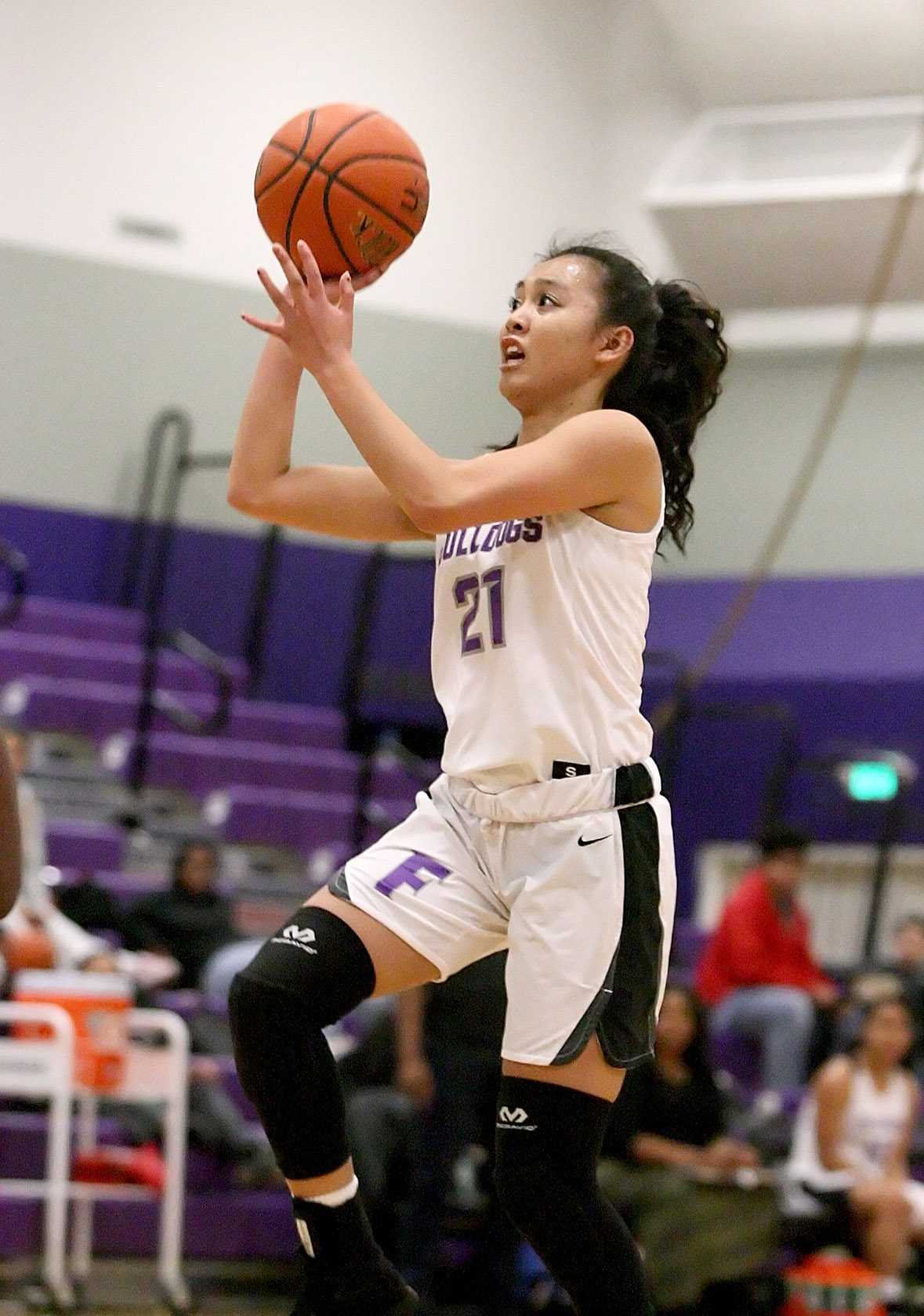 Precious Serafica of Foster glides to the basket as she takes a shot.