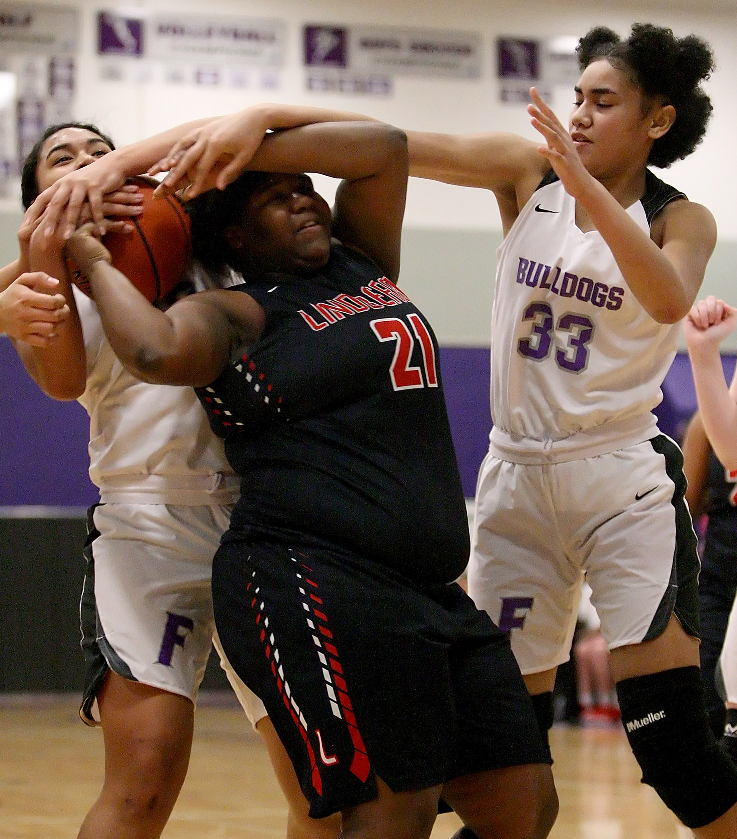 Sanela Musinovic and Emolani Morris of Foster get a little physical with Lindbergh's Unique Taylor reaching for the ball.