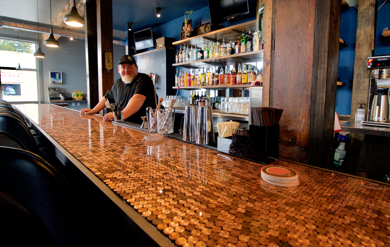 Owner Michael Goldsmith behind the "Penny Bar". Photo by Patrick Robinson