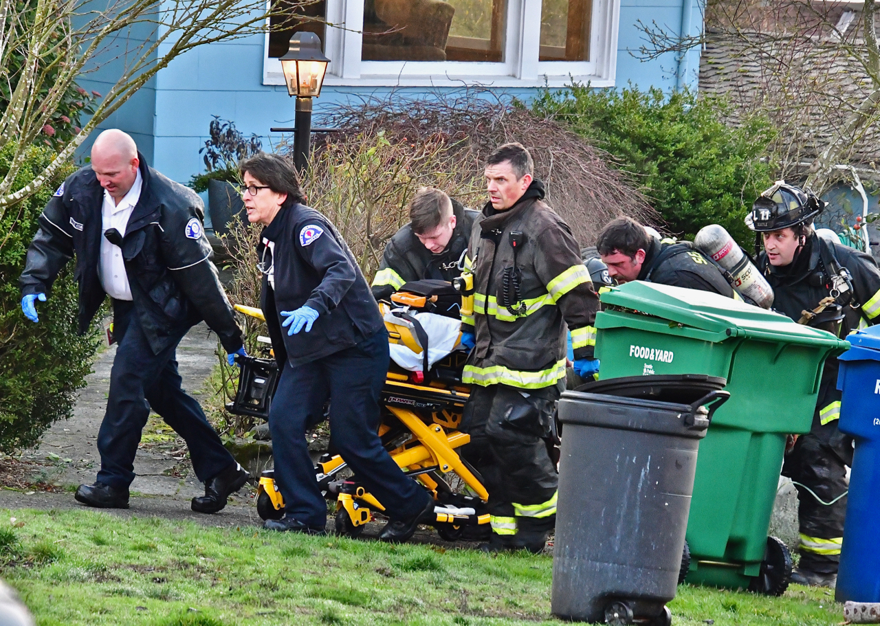 rushing to ambulance. West Seattle fire