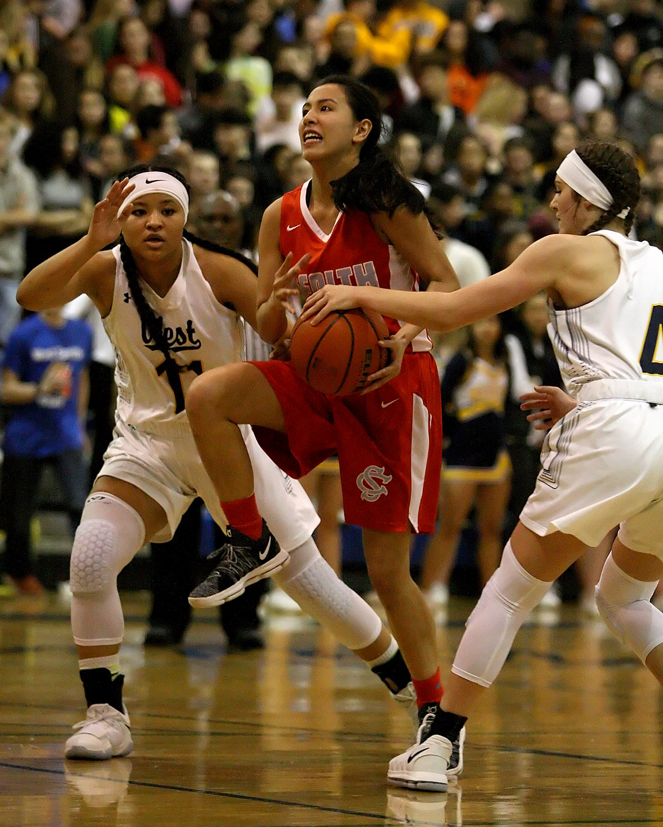 Kelsey Lenzie of West Seattle knocks the ball away from Chief Sealth's Celia LaGardia, as she goes in for a layup.