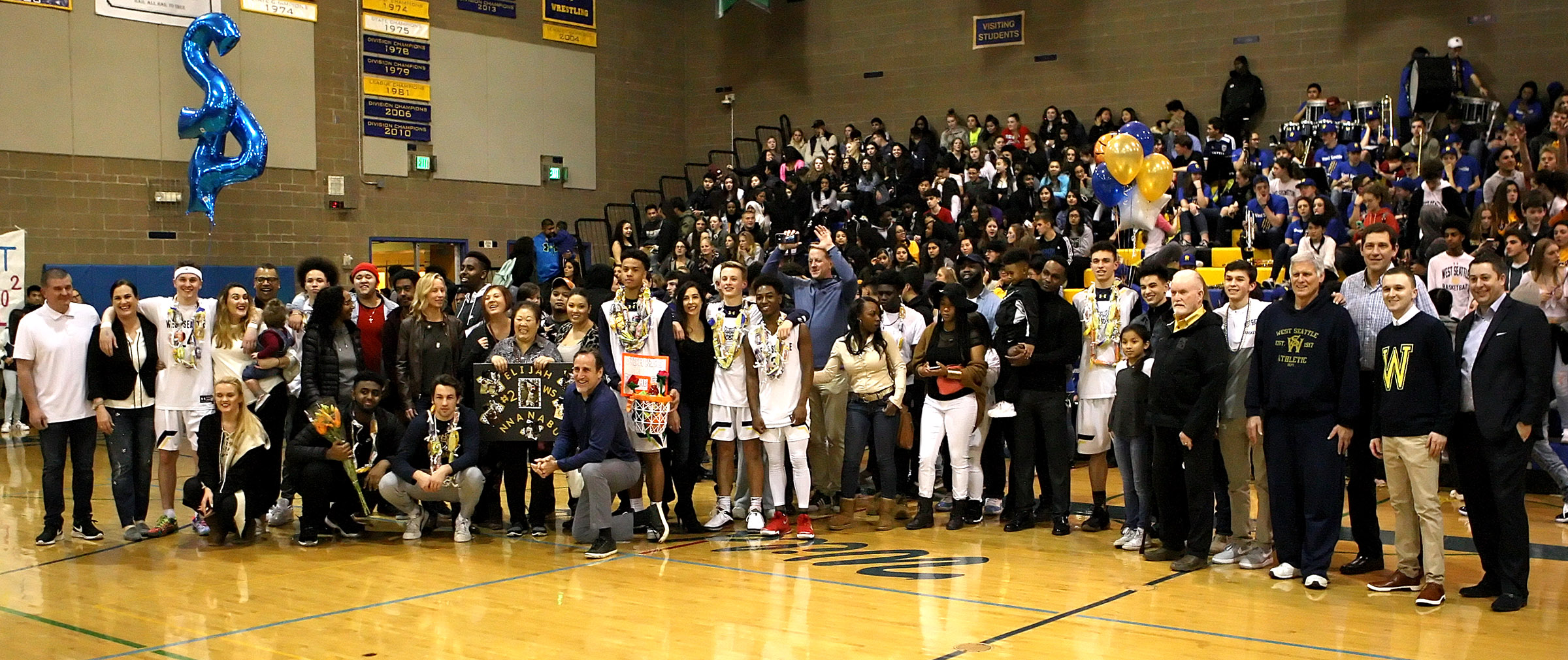 The West Seattle senior boys pose for a pregame photo with their families.