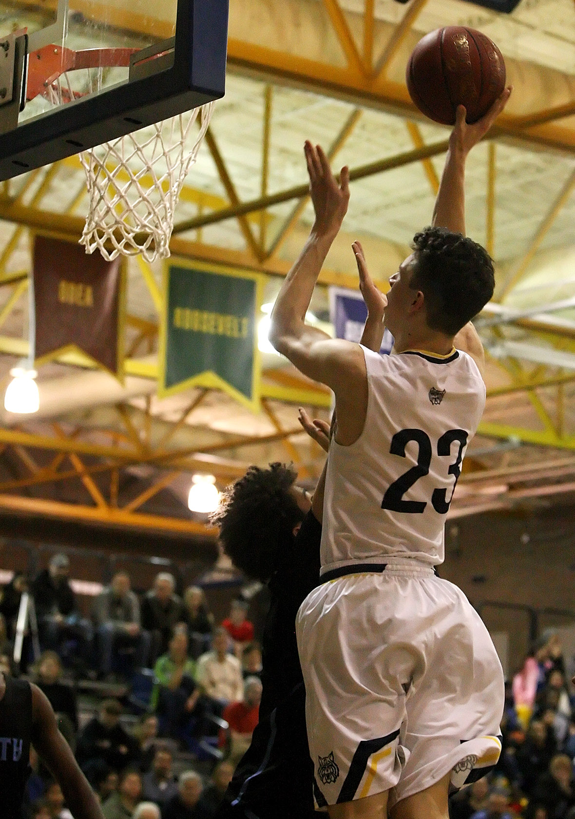 Anthony Giomi of West Seattle score a basket against the defensive pressure from Chief Sealth's Sadique Calloway.