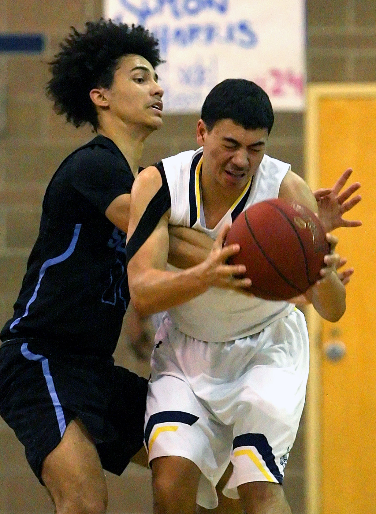 Marcus Collins of West Seattle is intentionally fouled by Chief Sealth's Sadique Calloway to stop the clock near the end of the game.