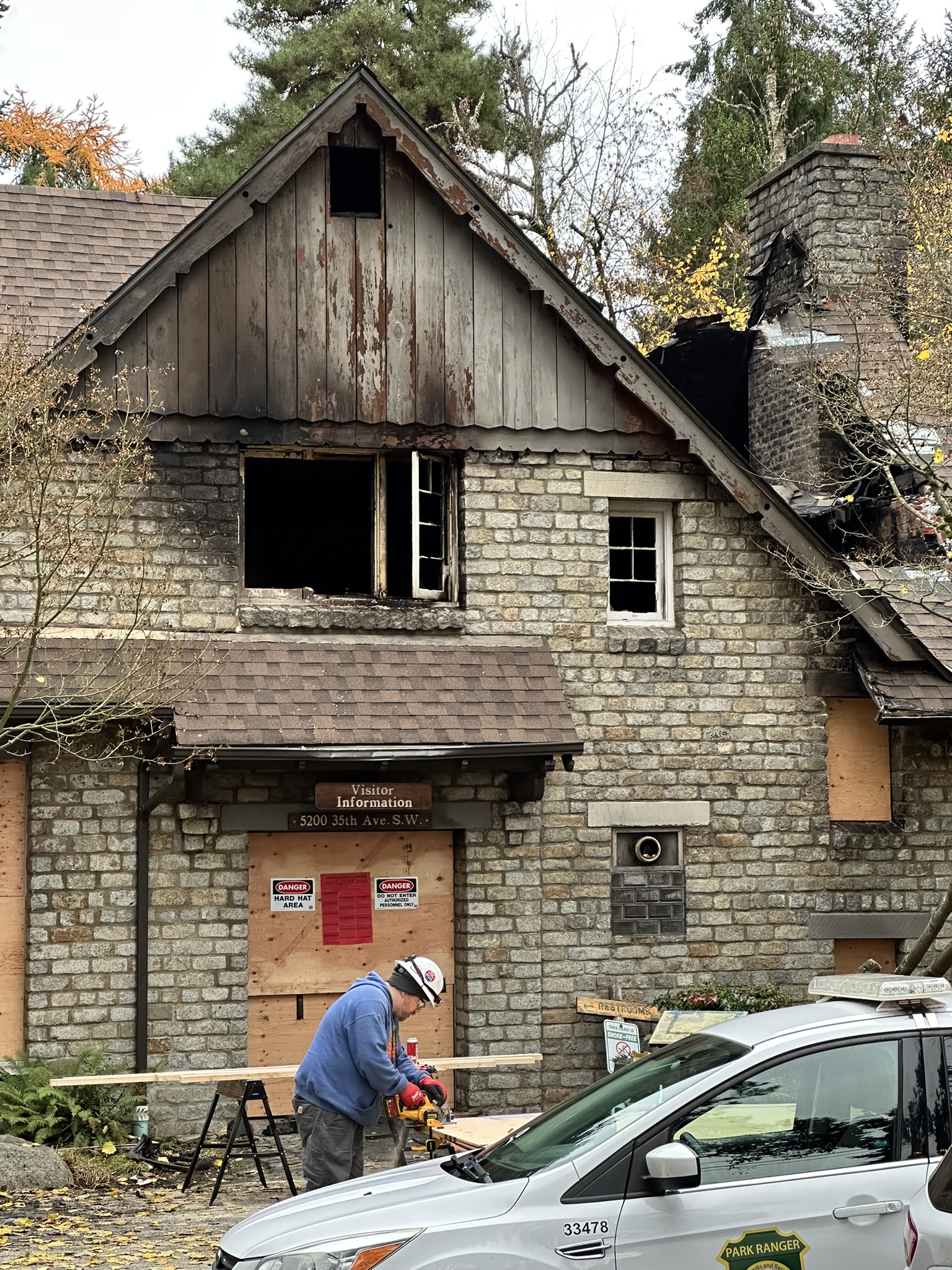 crews working to seal up damaged building