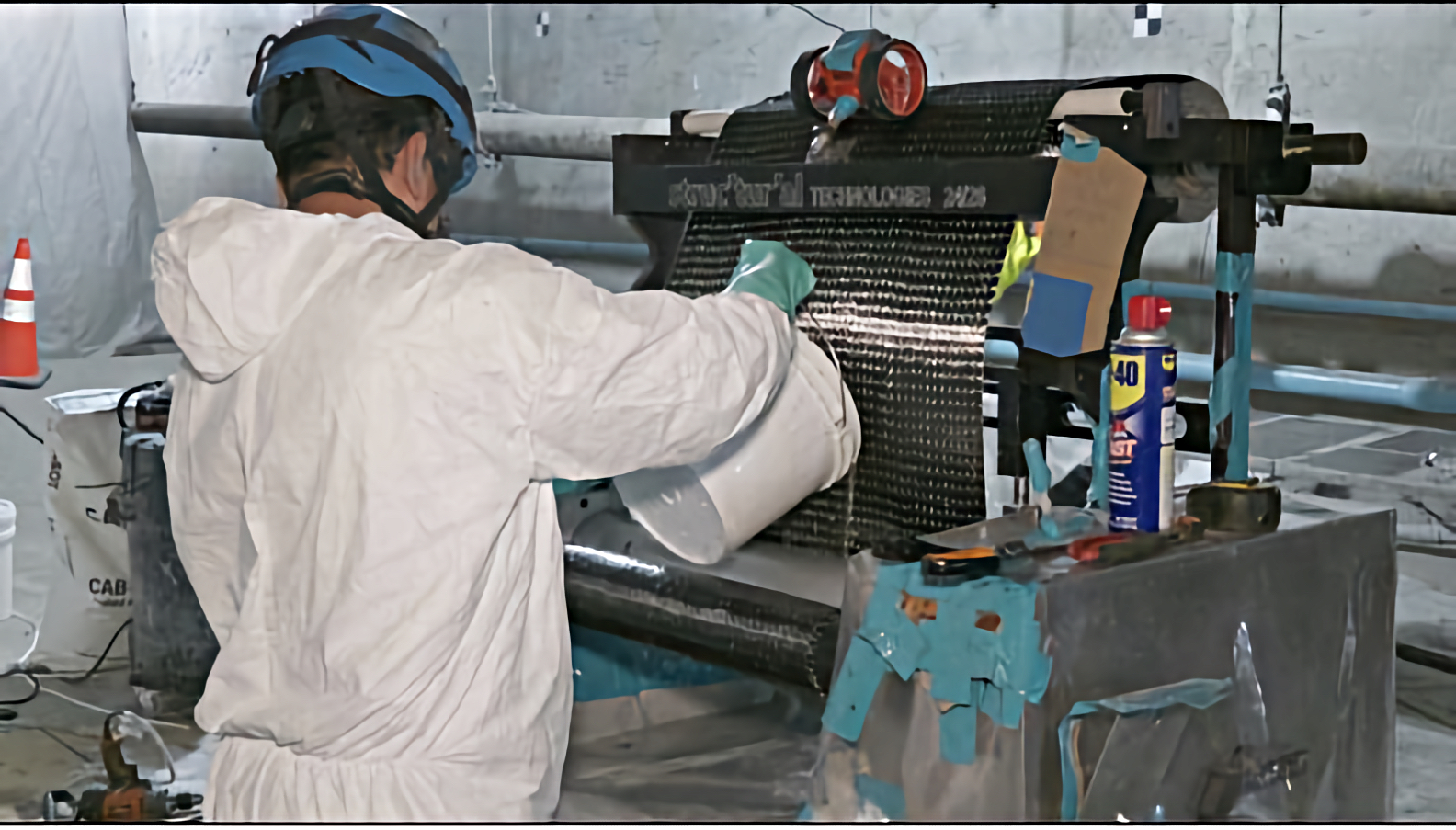 Pouring a bonding compound into the carbon-fiber press to strengthen the wrap.