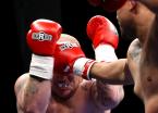 Thompson lands a jab between the gloves of Shay.