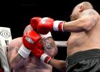 An uppercut from Thompson meets it's mark between the gloves of Shay.