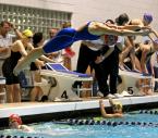 Mariah Crockett leaves the starting block as Audrey Griggs (bottom left) touches the wall in the 4 x 100 yard freestyle.
