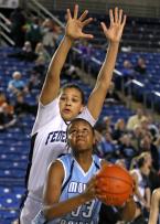 Mt. Rainier's Kiana Gandy is shadowed by Federal Ways Talia Walton going to the basket.