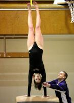 Cara Bender of Highline goes vertical with her front handspring on vault with coach Kevin Tessandore on the spot.