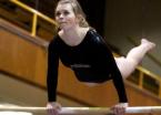 Jennalee Gould of Highline performs a cast on bars.