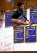 Jennifer Troung of Evergreen leaps high during her Wolf jump on the beam.
