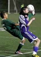Florian Ferencak of Foster tries to protect himself against a high kick from Evergreen's Saul Felix
