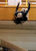 Highline's Mia Alvarez keeps her eyes on the beam during her back flip.