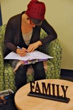 A mom signs up to join. Photo by Patrick Robinson