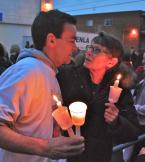 John Peck hugs a family friend at the vigil. Photo by Patrick Robinson