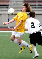 Sam Clement of TJ chest traps the ball while getting pushed in the back. IMG_7621 5x7 300dpi.jpg