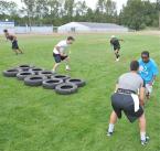 Huy Huynh, coach Erik Heineman, Andre Marticio, Daniel Netere and David Ordenana run a mock play from scrimmage.  news04-2.jpg
