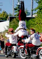 Seattle's own "Cossacks Motorcycle Stunt Team" performs a head and shoulder stand.