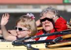 Times/News columnist Earline Byers, the one of the parade grand marshals, covers her eyes from the bright sunlight.