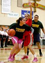 An Evergreen player maneuvers herself baseline to the basket.