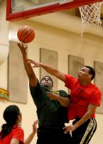 On a lay-up a Tyee player fouls an Evergreen player.