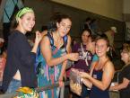 Kennedy swimmer, and, captain, Michelle Callson, passing out donut holes to Highline team swimmers, Emma Murray and Sophia Cassam, in a show of good sportsmanship after a recent meet at the Foster pool. Cassam (middle) won the diving portion of  the meet. Callson was on the winning 200 free relay team for the Lancers. Murray is a  state quality swimmer, but out with injury for this meet.