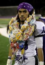 Patrick Saau of Foster is adorned with edible leis on Senior Appreciation Night.