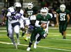 Evergreen's Ryan Thol scampers away from Foster would be tacklers.