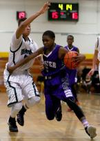 Jaloni Garner of Foster drives past Evergreen's Malikn Satchell.