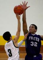 Calvin Thai of Evergreen has his shot rejected by Foster's Keith Hill.