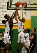 Players go for a rebound near the basket.