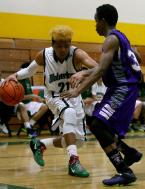 Joseph Thatch of Evergreen drives the baseline against Foster's Othniel Fleurine.