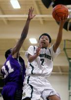 Richard Nguyen of Evergreen puts up a shot against Foster's Othniel Fleurine.
