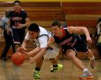 Brandon Valencia of Evergreen and Kennedy Catholic's Parker Diller try to gain control of the ball.
