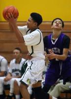 Elijah Nnanubu of Foster intentionally fouls Evergreen's Richard Nguyen in the final seconds of the game.