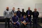 Some of Foster Bulldogs' wrestlers, along with their coach, Patrick Kalalau, on the left,  and, assistants, Troy Ferris, and, Ed Wovidich, on the right