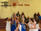 The Lady Lions' and Eagles' players looking at a ball in the air, as, someone will get it, in a  girls basketball game on Friday.