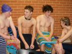 Four of the Wolverines/Totems/Pirates swimmers enjoying each others' company  during a slight break in the action, leading up to their races. They are (left to right), Kodie Frankele, Tyler Goodspeed, Nate Williams, Alex Hoppe.