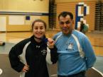 The Rams's Giuliana Pepe showing her first place medallion for winning her finals'  wrestling match, with her coach, Ruben Cortinas, at the Highline School District Invitational in the Mount Rainier gym Saturday.