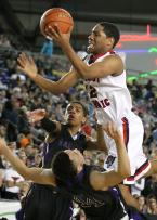 A.J. McGrew of Kennedy Catholic takes the ball to the hoop against defensive pressure from Garfield.