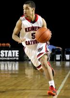 Keannu Royster of Kennedy Catholic accidentally steps on the sideline bringing the ball up court.