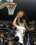 Taking the ball to the hoop, Michael Sasonoff of Kennedy Catholic has his shot blocked by Garfield's Jaylen Nowell.