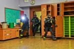 SWAT team members rush into a classroom. Photo by David Rosen
