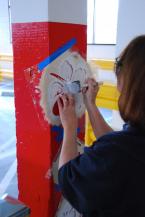 A crew member added some stenciling to a column in the parking garage. Photo by Patrick Robinson