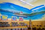 A corner mural of the Alki Point Lighthouse and Blue Angels flyover. Photo by David Rosen